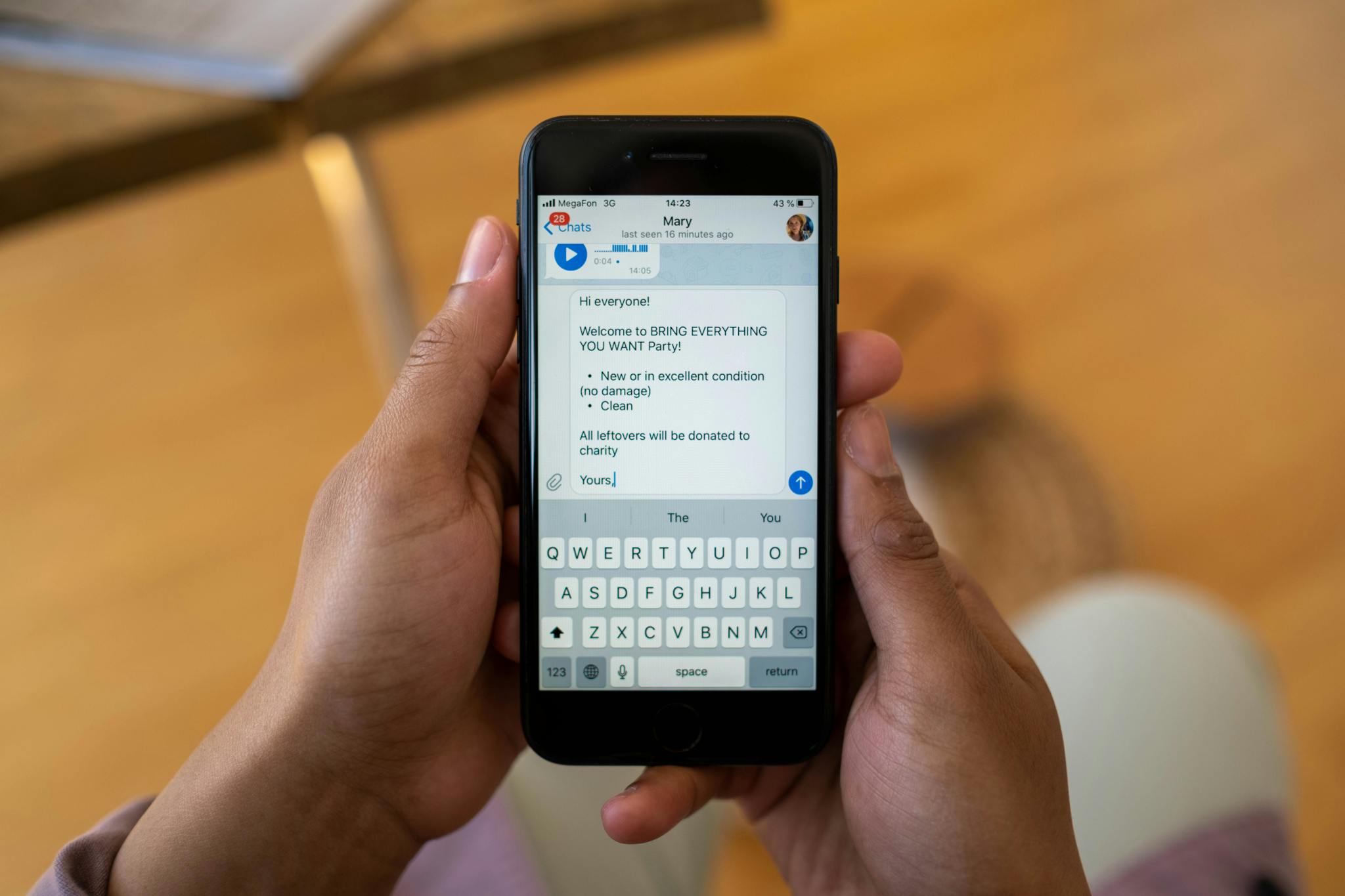 How to Generate a QR Code For SMS Texts – Free SMS QR Code 7 Person holding a smartphone displaying a text message about a party event indoors.